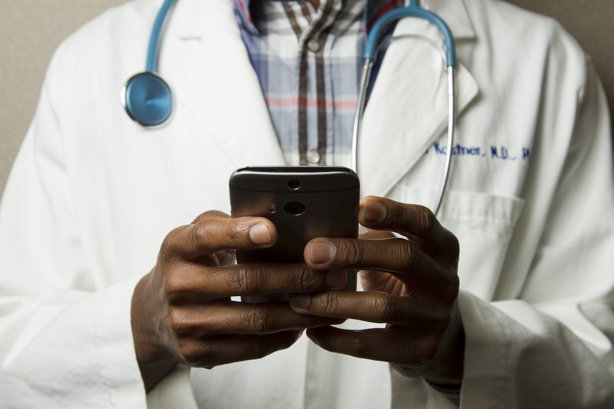 Clinician using a mobile device to coordinate care